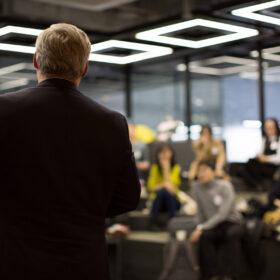 Business Professional Person Presenting to a Group of People. Discussion. Business Professional Person Presenting to a Group of People. Discussion.